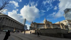 a large building with people walking in front of it at Nirbhao in Birmingham