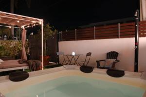 a swimming pool in a backyard at night at Studio Alpha - relax e jacuzzi in Syracuse +23 photos