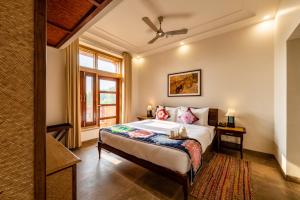 a bedroom with a bed and a window at Seraibagh Ranthmabore in Khilchipur