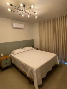 a bedroom with a large bed and a window at Refúgio das Araucárias in Nova Petrópolis