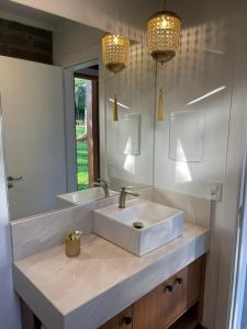 a bathroom with a sink and a mirror at Refúgio das Araucárias in Nova Petrópolis +11 photos