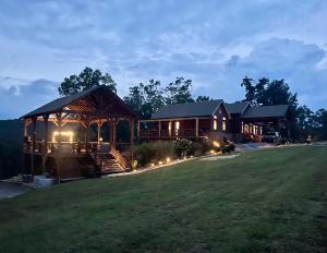 a large house with lights on the lawn at The Dogwood Inn in Blue Ridge