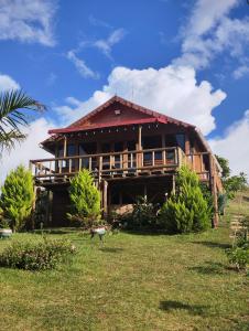 a large wooden house on a grass field at Cabañas Buenos aires in Guadalupe
