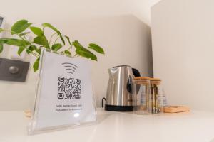 a book sitting on a counter next to a coffee maker at Sunrise Stay in Male City +15 photos