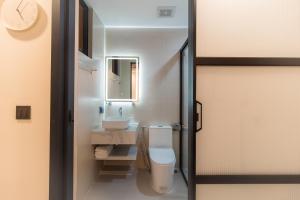 a bathroom with a toilet and a sink at Sunrise Stay in Male City