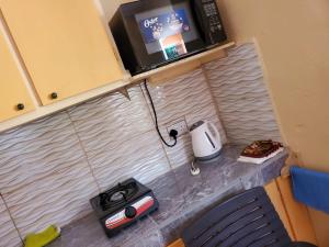 a kitchen counter with a microwave and a toaster and a toaster at EMME Escape in Victoria