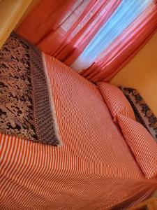 a bed in a room with a red canopy at EMME Escape in Victoria