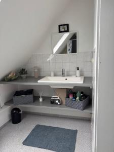 a bathroom with a sink and a mirror at Apartment Düte in Erpen