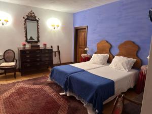 a bedroom with a large bed and a mirror at Casa de Nossa Senhora da Piedade in Ponte de Lima +40 photos