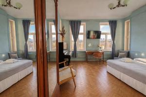 a large room with two beds and a mirror at 4th Floor Bed and Breakfast in Warsaw