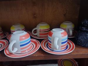 a group of cups and plates on a shelf at Pro hébergement in Dakar