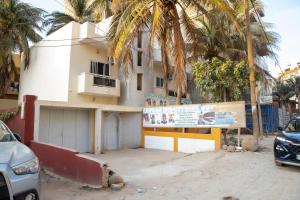 a building with a sign in front of it at Pro hébergement in Dakar
