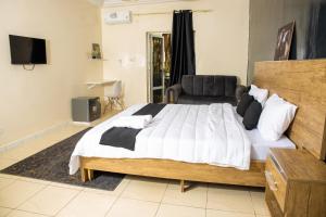a bedroom with a large bed and a television at Pro hébergement in Dakar