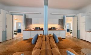 a large living room with a couch and a kitchen at 4th Floor Bed and Breakfast in Warsaw