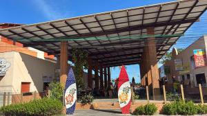a wooden pergola with two surfboards under it at Sol, mar, equilíbrio perfeito praia do frances! in Marechal Deodoro +59 photos