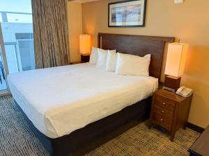 a bedroom with a large bed with a phone on a night stand at Towers at North Myrtle Beach in Myrtle Beach +45 photos