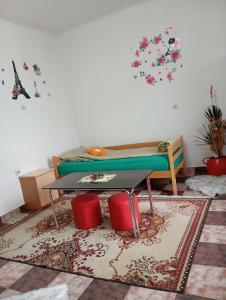 a living room with a table and a table sidx sidx sidx at Apartment Natti in Sremska Kamenica