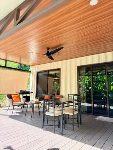 a patio with a table and chairs and a television at M&M Container Home in Sardinal