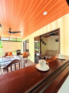 a living room with a wooden table with cups on it at M&M Container Home in Sardinal