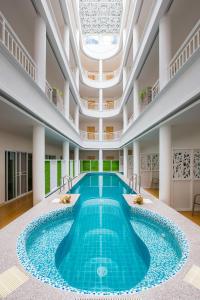 a large pool in a building with a ceiling at Hi Chiangrai Hotel-SHA Extra Plus in Chiang Rai