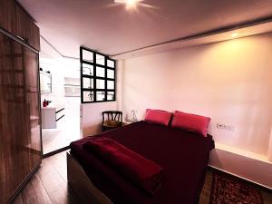 a bedroom with a bed with red pillows on it at DreamCatcher Paragliders in Tamelalt +28 photos