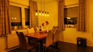 a dining room with a wooden table and chairs at Bachoase Bischofsmais in Bischofsmais