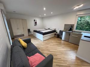 a living room with a couch and a bed at Königshof Studio in Monschau