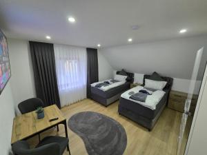 a living room with two couches and a table at Apartment an der Prims Nalbach in Nalbach