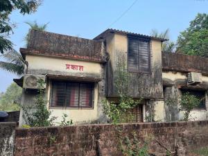 an old building with graffiti on the side of it at Prakash Banglow in Malvan
