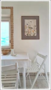 a white table and a chair in a room at La Fonte e l Ulivo in Ripatransone +10 photos