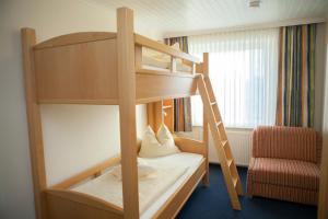 a bunk bed in a room with a ladder at Hotel Mellum in Wangerland