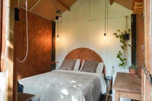 a bedroom with a bed with a wooden headboard at Ecofazenda Lodge in Bofete +137 photos