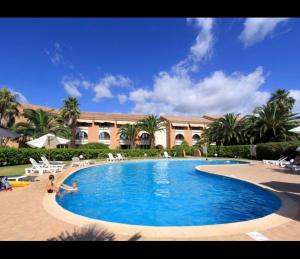a large swimming pool in front of a building at Corse Appartement Sognu di Mar Marine de Bravonne à Linguizzetta in Linguizzetta