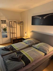 a bedroom with a bed with two bags on it at Lakeview Apartment in Schluchsee