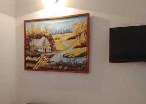 a painting of a farm on a wall at Avocado Lodge in Lushoto