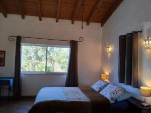a bedroom with a bed and a large window at Quinta do Paraiso in São Teotónio +181 photos