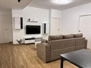 a living room with a couch and a flat screen tv at Apartamento Maruchi in Santa Cruz de Mudela