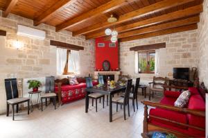a living room with a couch and a table at Drys Stone House in Miriokéfala