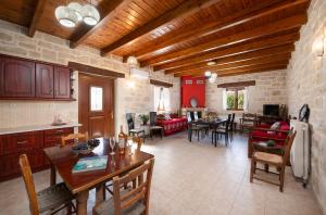 a kitchen and living room with a table and chairs at Drys Stone House in Miriokéfala
