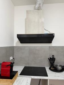 a kitchen with a counter top with a red appliance at Petrocelli apartment in La Romanina