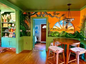 a dining room with a table and a colorful wall at Creekside Paradise in Tybee Island