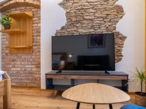 a living room with a large flat screen tv at Apartmán Jimi Hendrix in Nymburk