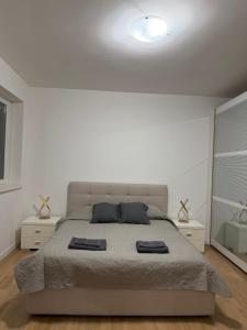 a bedroom with a large bed with two night stands at Petrocelli apartment in La Romanina
