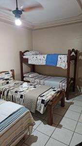a room with three beds and a ceiling at Casa Meão in Recife +20 photos