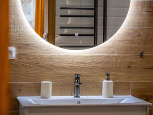 a bathroom with a sink and a mirror at Apartmán Mick Jagger in Nymburk
