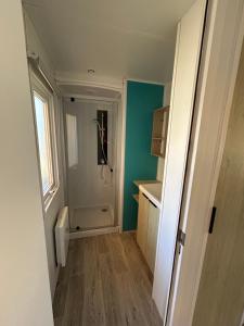 a bathroom with a walk in shower and a toilet at Camping les Olyats in Seignosse