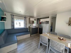 a kitchen and dining room with a table and chairs at Camping les Olyats in Seignosse