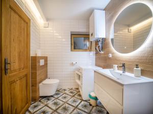 a bathroom with a sink and a toilet and a mirror at Apartmán Mick Jagger in Nymburk +2 photos