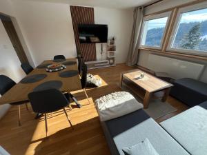 a living room with a table and a couch at Aldrovské Trio in Vítkovice