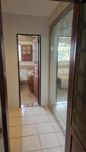 a hallway with a door and a mirror in a room at Casa Meão in Recife